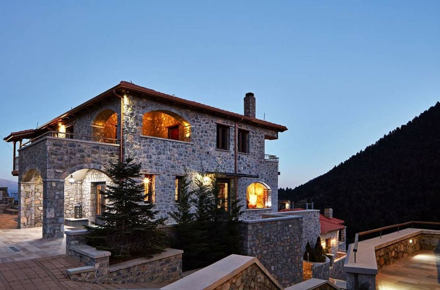 one side of illuminated Kalogris Winery stone building by night
